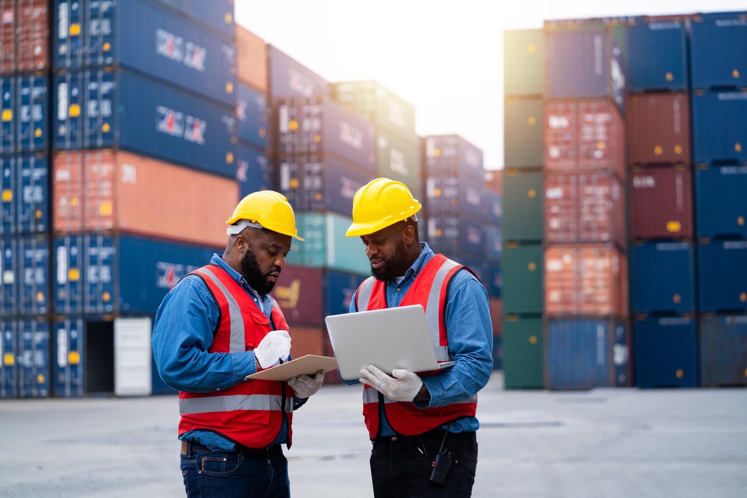 Workers inspecting shipping containers